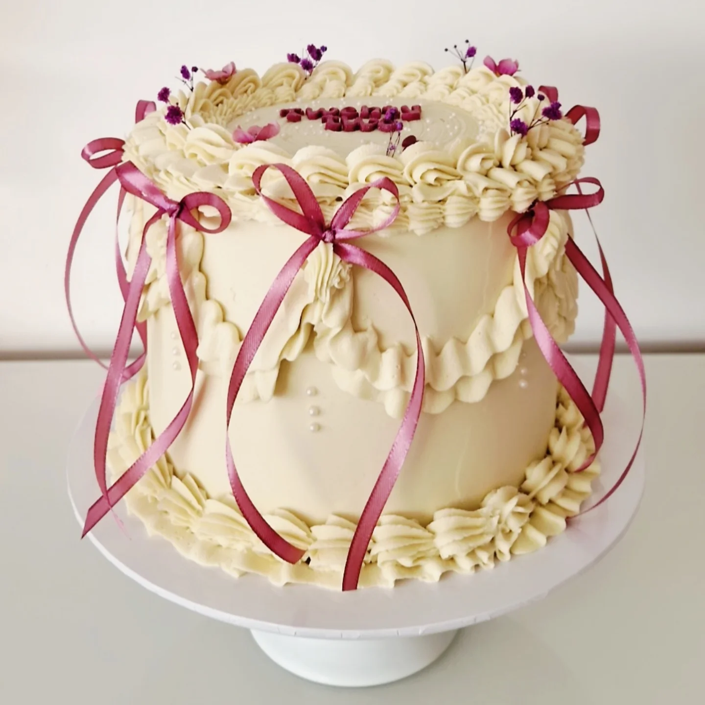 Vintage cake with burgundy ribbons